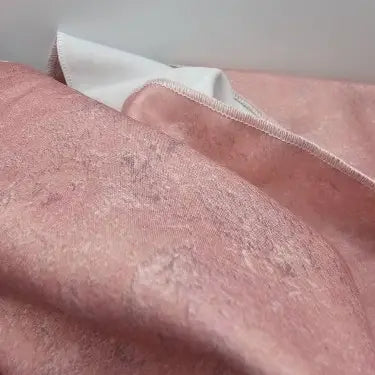 Close-up of Rose Marble reusable fabric gift wrap showing pink polycotton with a mottled grey and white pattern.