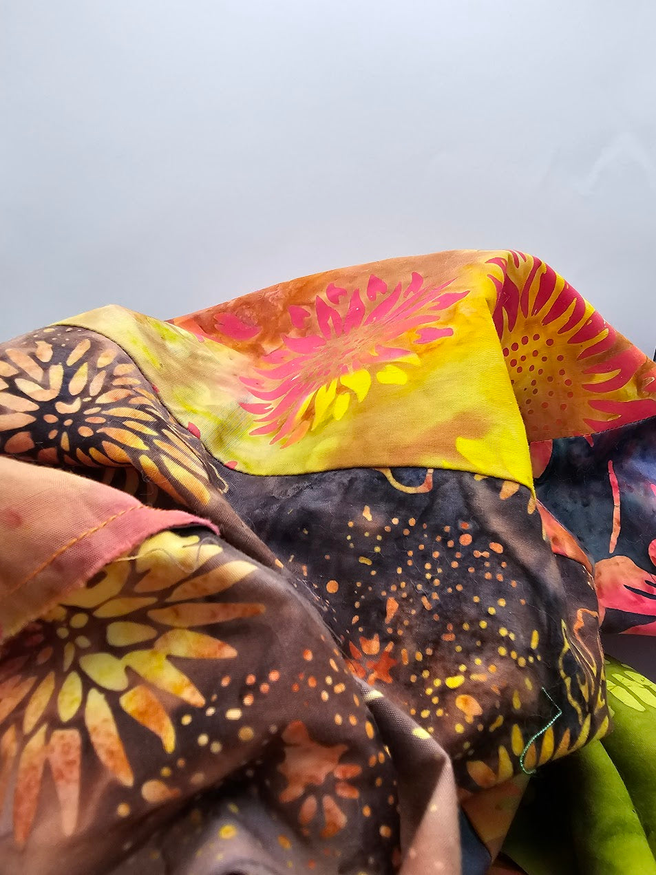 Close-up of Boho Patch reusable fabric gift wrap showing colourful patchwork cotton, mixed prints and black stitched edging.