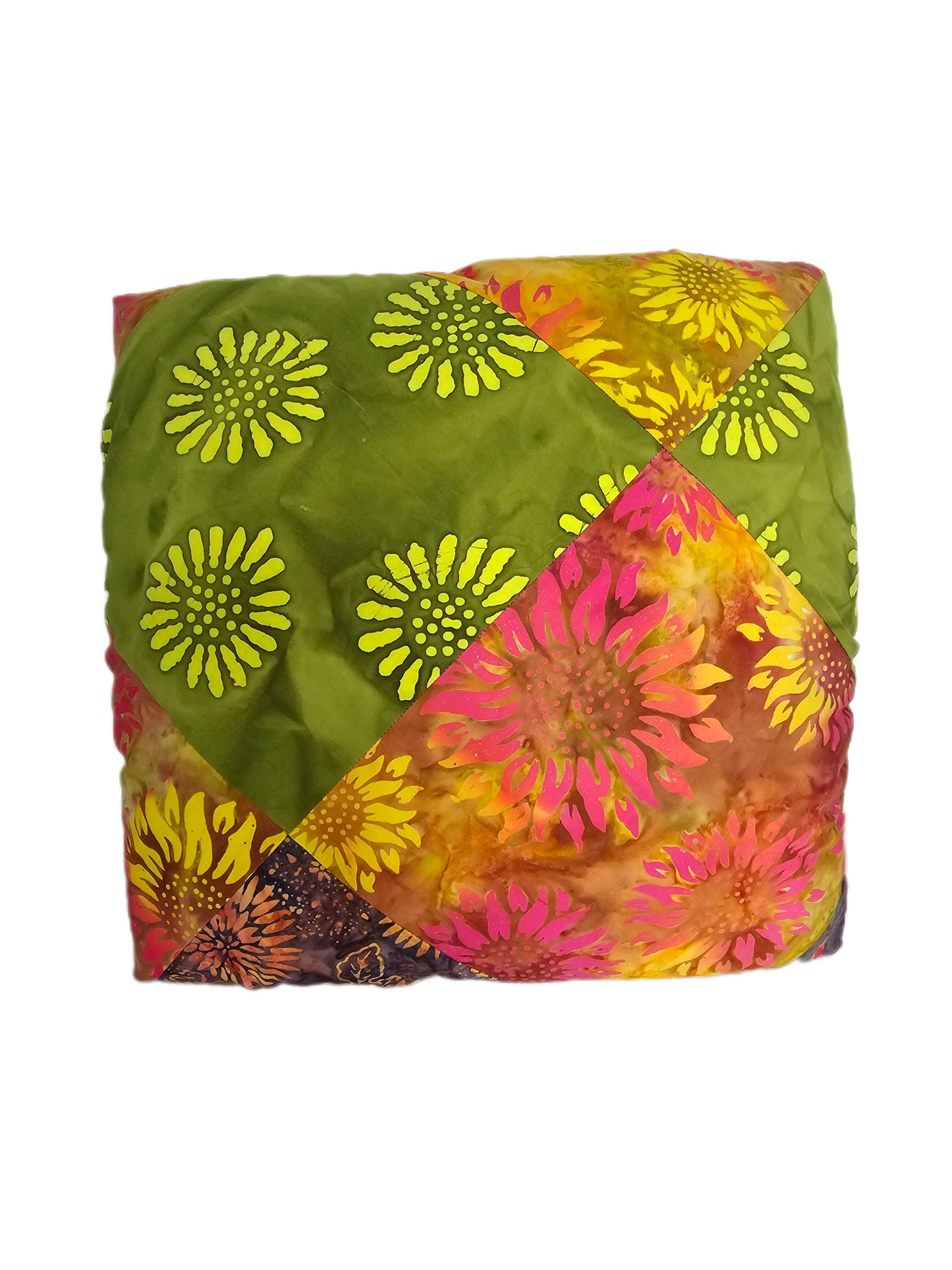 Boho Patch reusable fabric gift wrap wrapped around a gift, showing colourful patchwork cotton in green, yellow, pink and orange.