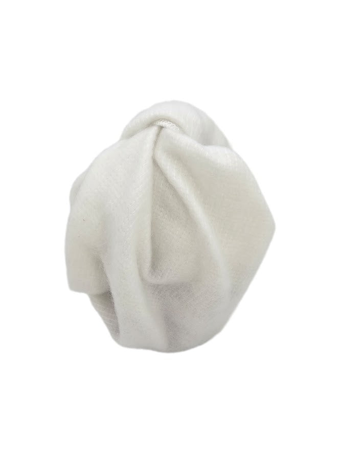 Protector Wrap reusable white protective fabric tied around a gift, providing a soft cushioning layer for delicate items.