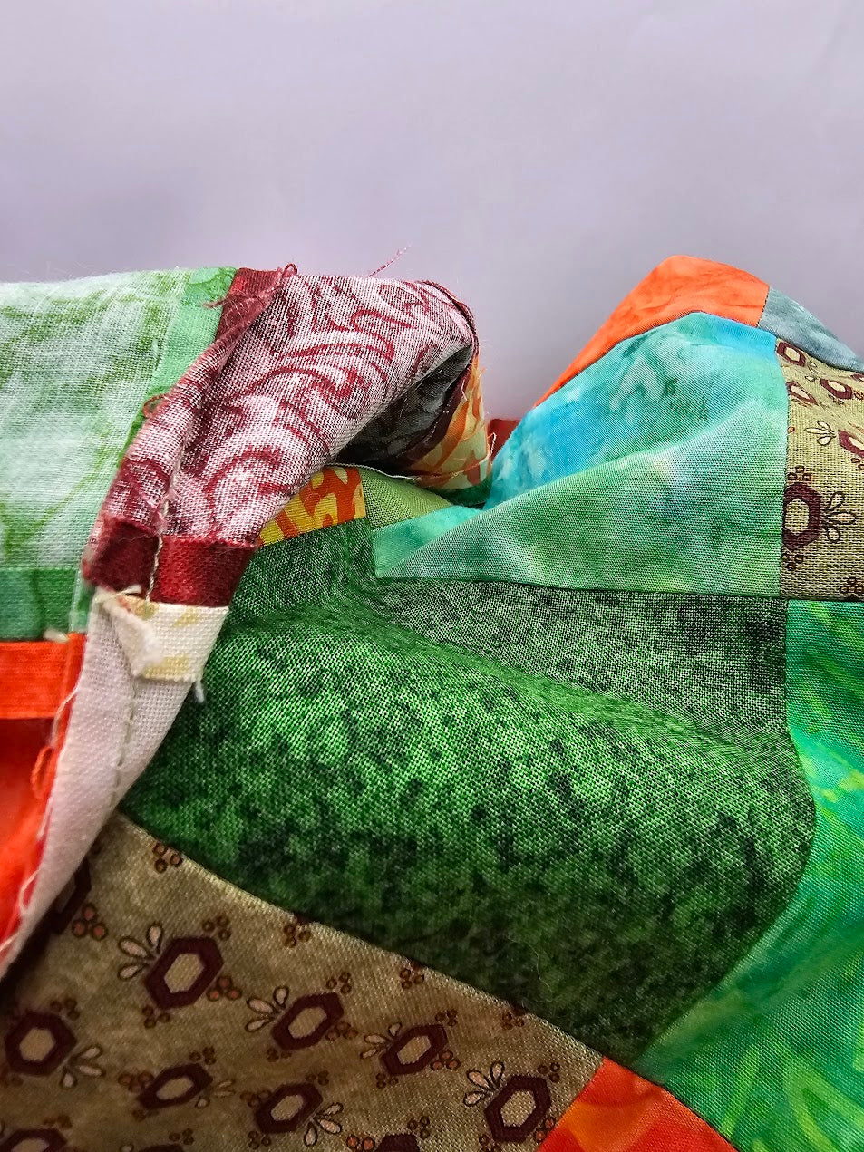Close-up of Bohemian Chic reusable fabric gift wrap showing multicoloured patchwork cotton, textured weave and stitched seams.