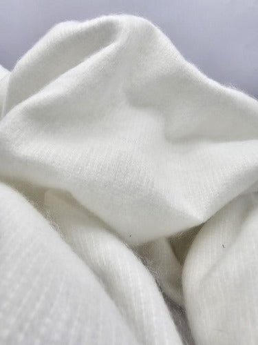 Close-up of Protector Wrap reusable white protective fabric showing its soft textured polyester surface.