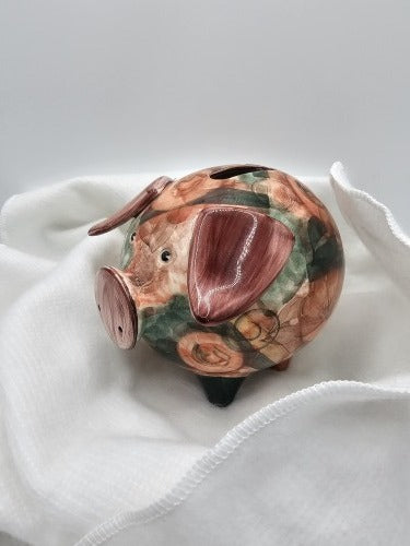 Ceramic piggy bank placed on white Protector Wrap fabric, demonstrating protective wrapping for a fragile gift.
