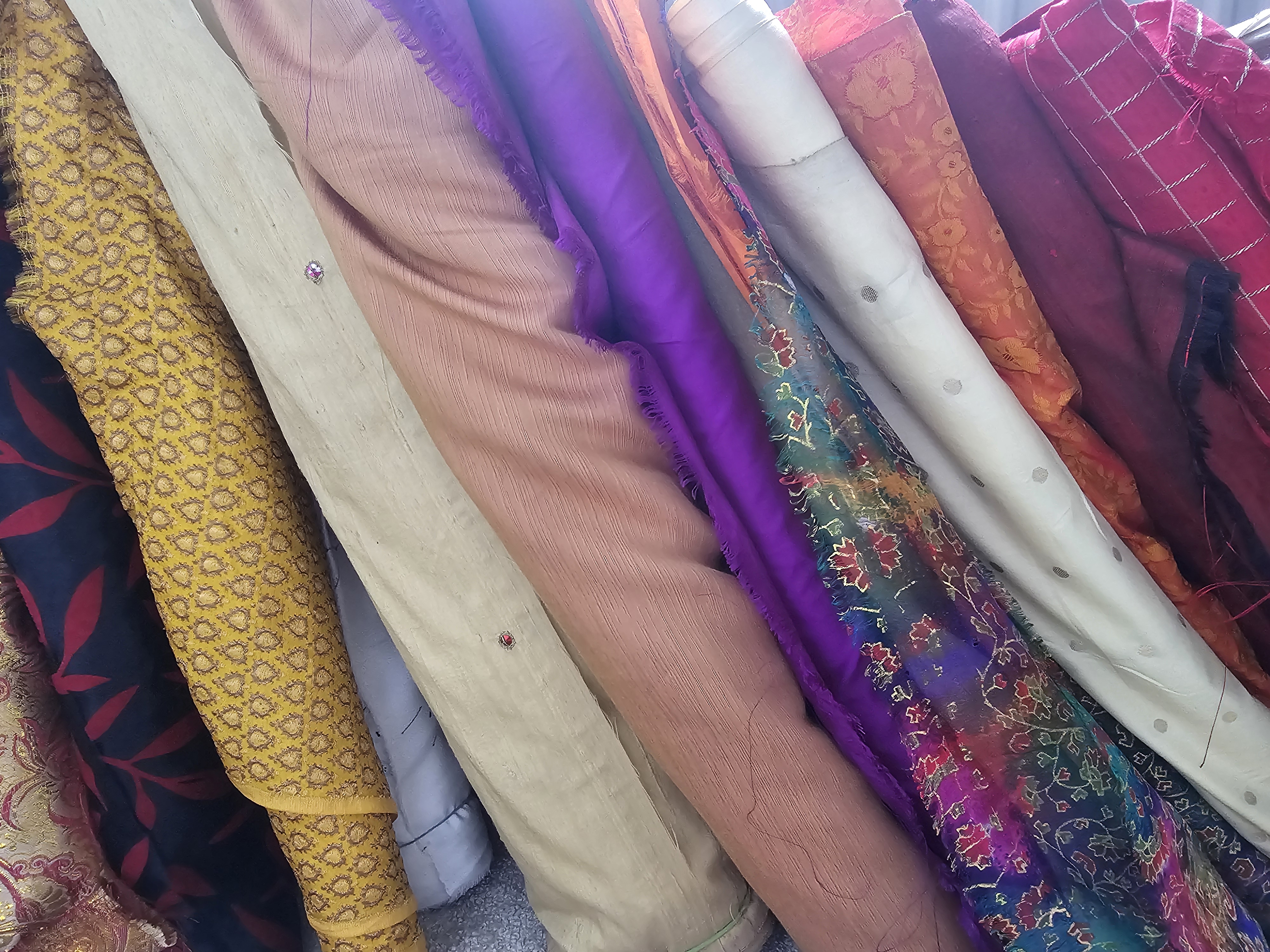 An image of different colours and patterned fabric, lined up side by side