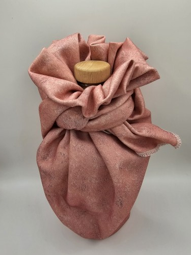 Bottle_wrapped_with_pink_fabric_gift_wrapping_fabric_tied_with_a_bow_with_the_top_of_the_bottle_showing_image