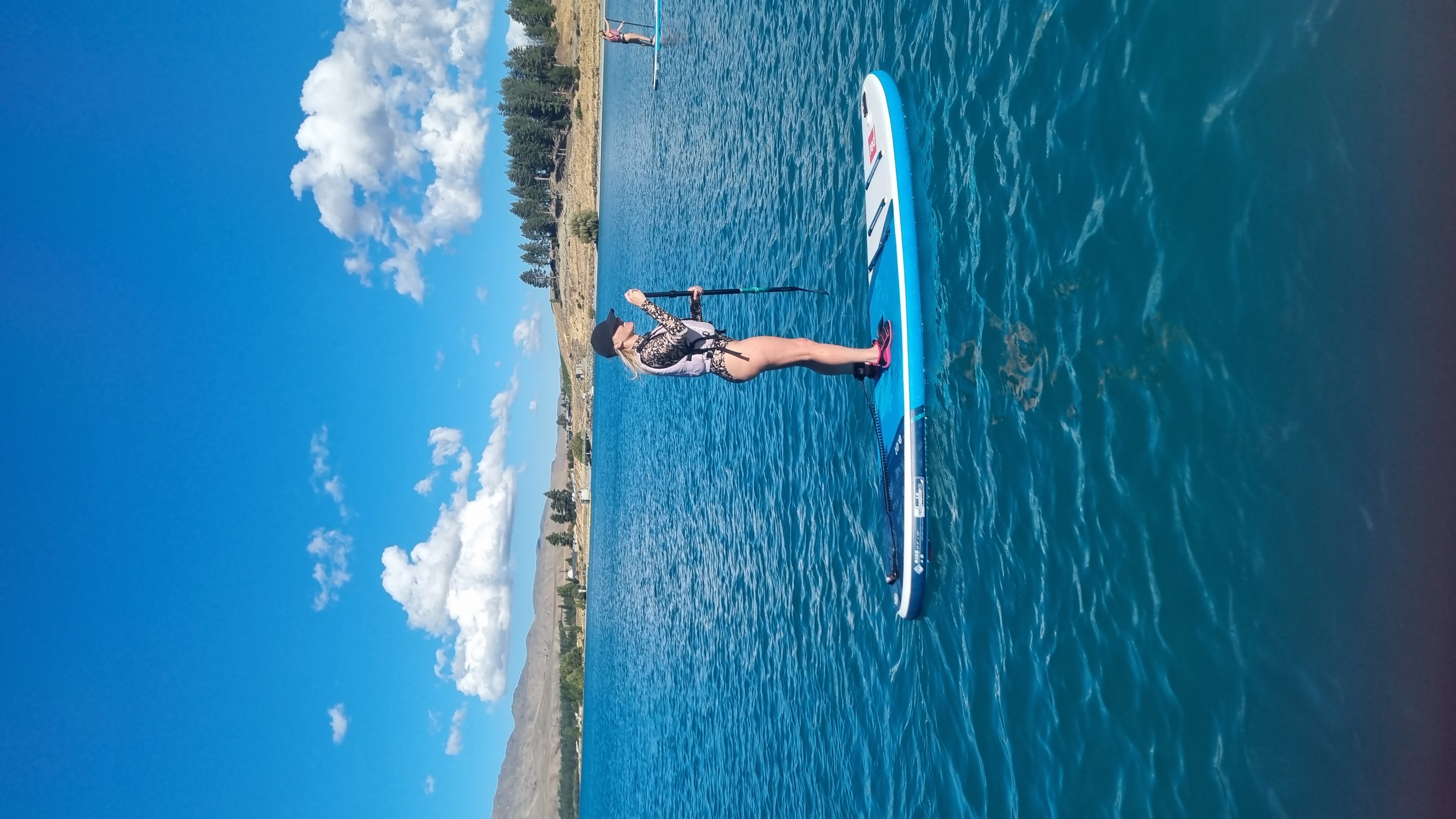 woman Stand up Paddle boarding on a lake