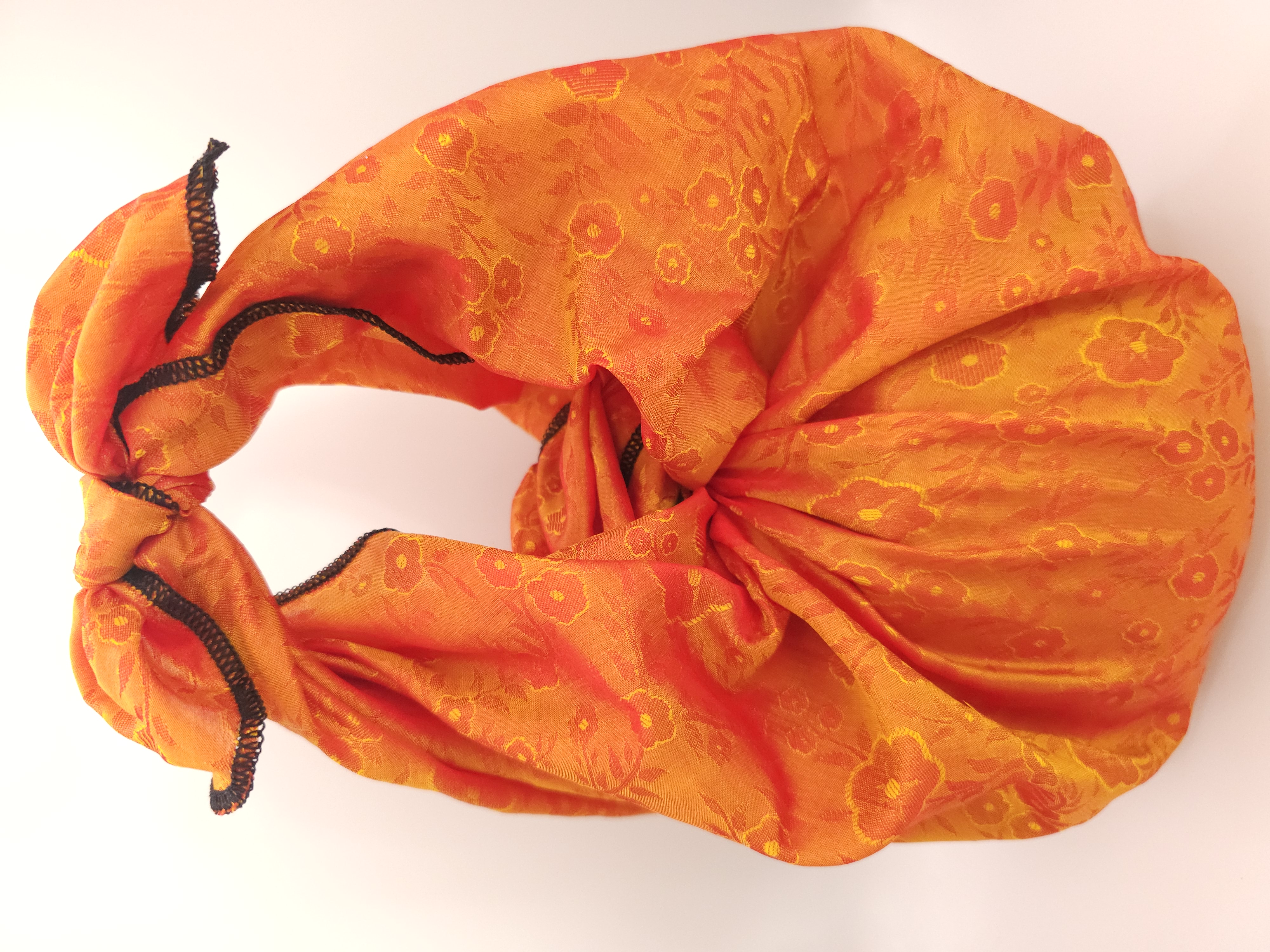 Jug_wrapped_in_orange_floral_wrapping_fabric_with_handle_to_carry